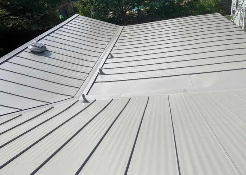 Solar attic fan installed on a metal roof for Roof Ventilation in Liberty Triangle